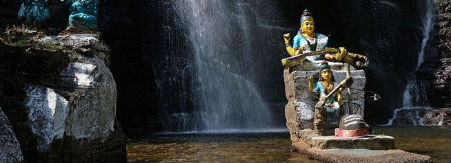 Waterfall with sacred deities carved in central highlands Sri Lanka